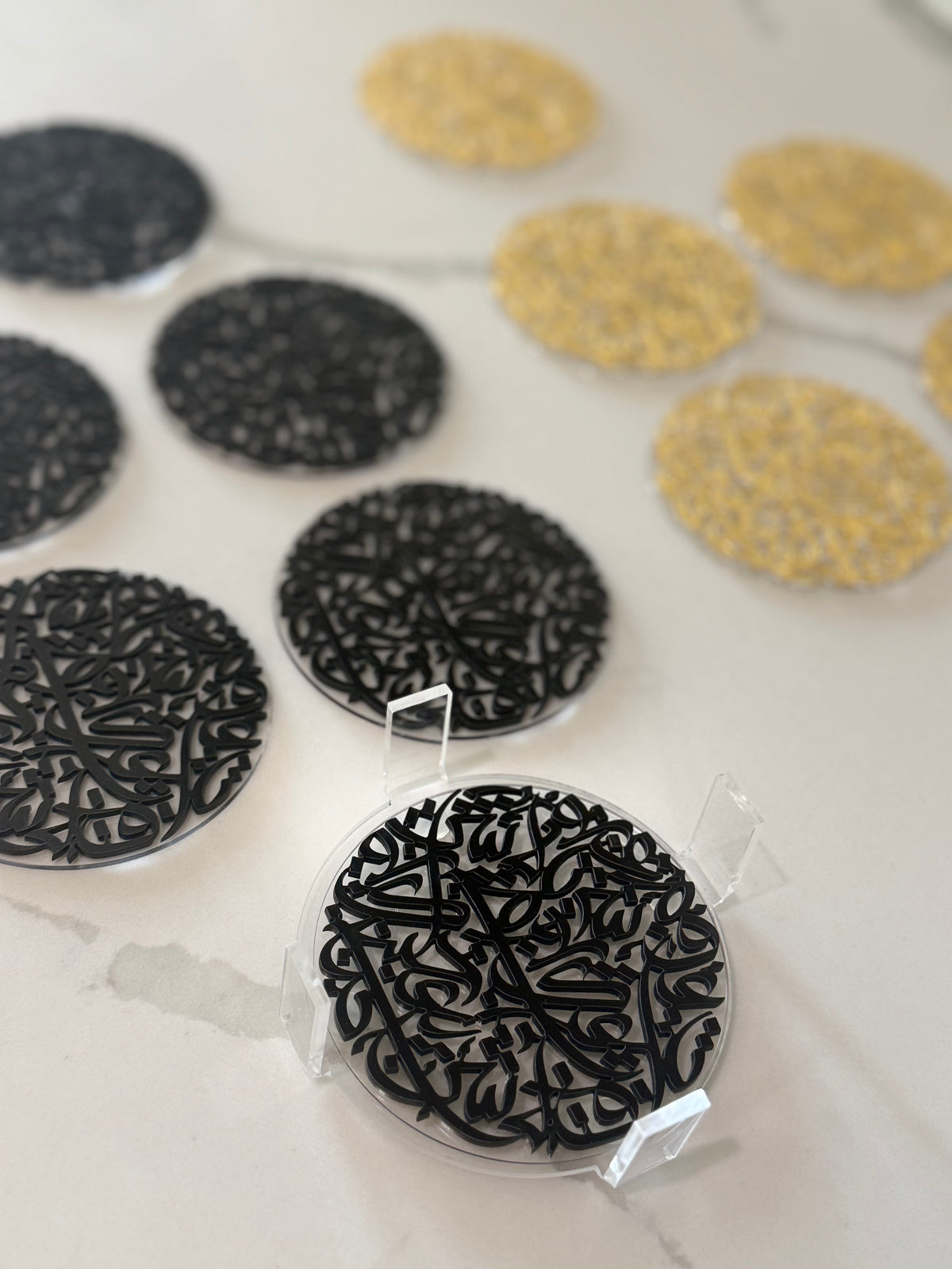 7 pcs Arabic Calligraphy Acrylic Coasters by Khatt By Randa | Black & Gold Set of 6 & Coaster Holder